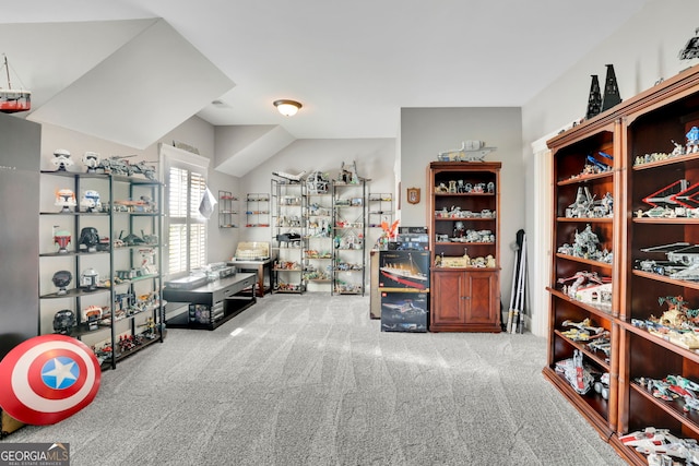 walk in closet with carpet and lofted ceiling