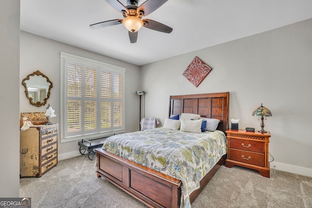 carpeted bedroom featuring baseboards and ceiling fan