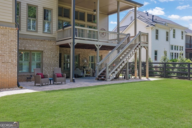 rear view of property with a yard, a patio, ceiling fan, and fence