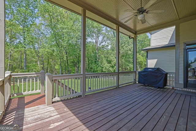 wooden deck featuring ceiling fan and a grill