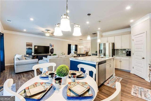 2316 Hastings Manor Ln, Hampton, GA 30228 - kitchen featuring white cabinetry, light stone countertops, visible vents, a center island with sink, and stainless steel appliances