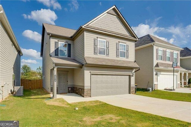2316 Hastings Manor Ln, Hampton, GA 30228 - craftsman-style home featuring concrete driveway, an attached garage, a front yard, central AC unit, and fence