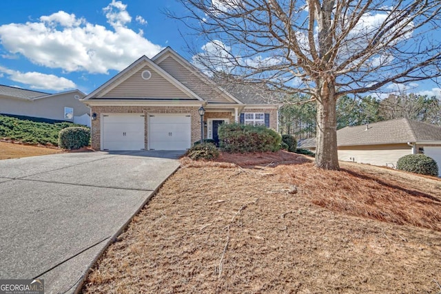 view of front of property featuring an attached garage, driveway, and brick siding