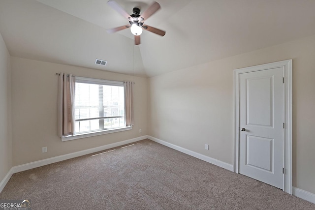carpeted empty room with visible vents, baseboards, a ceiling fan, and lofted ceiling