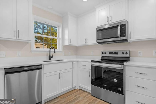 930 Burney Branch Cir, Blackshear, GA 31516 - kitchen with light countertops, appliances with stainless steel finishes, a sink, and white cabinetry