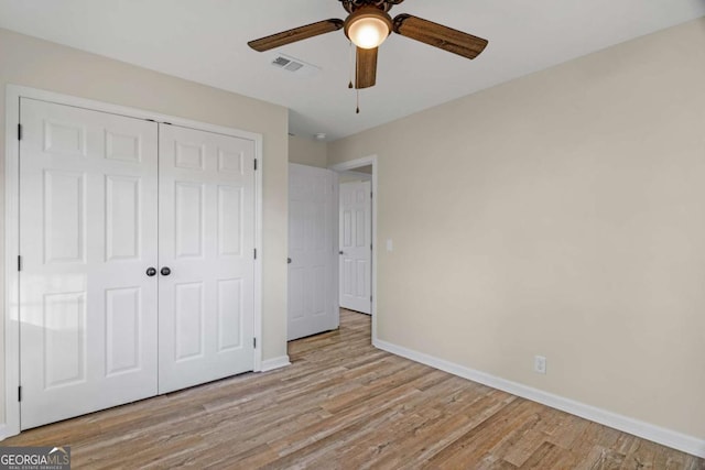 930 Burney Branch Cir, Blackshear, GA 31516 - unfurnished bedroom featuring visible vents, baseboards, a closet, ceiling fan, and wood finished floors