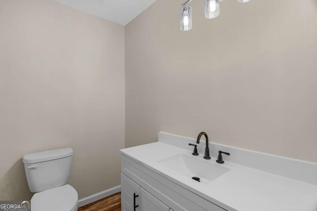 930 Burney Branch Cir, Blackshear, GA 31516 - bathroom with vanity, baseboards, toilet, and wood finished floors