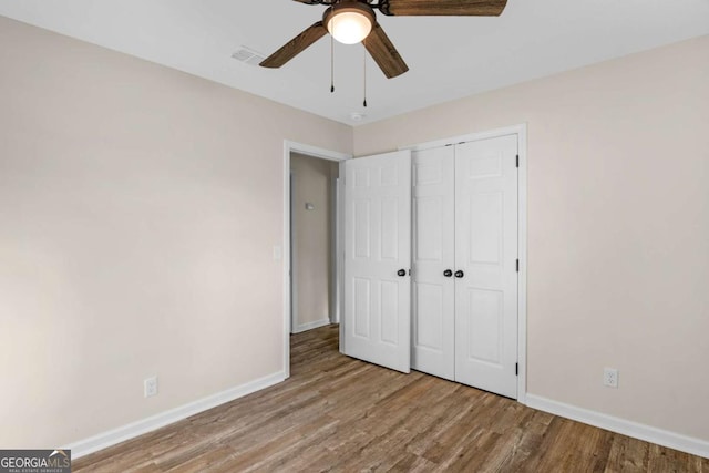 930 Burney Branch Cir, Blackshear, GA 31516 - unfurnished bedroom with visible vents, baseboards, a closet, ceiling fan, and wood finished floors