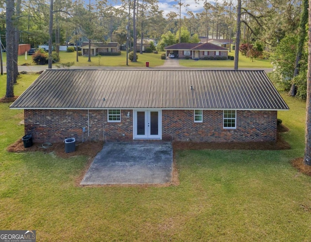 930 Burney Branch Cir, Blackshear, GA 31516 - rear view of property with a patio area, metal roof, a lawn, brick siding, and french doors