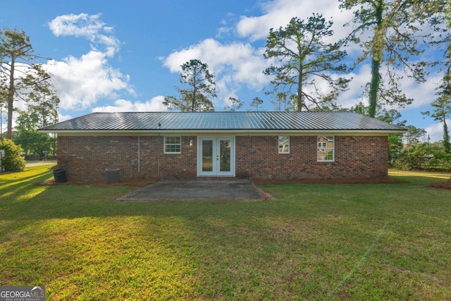 930 Burney Branch Cir, Blackshear, GA 31516 - back of property featuring a patio, metal roof, french doors, and a lawn