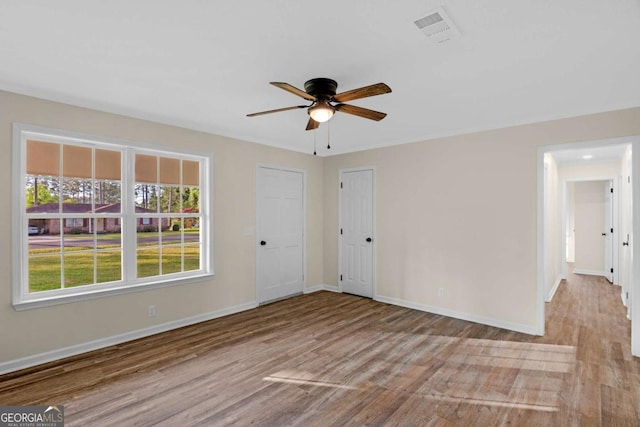 930 Burney Branch Cir, Blackshear, GA 31516 - empty room featuring wood finished floors, baseboards, a ceiling fan, and visible vents