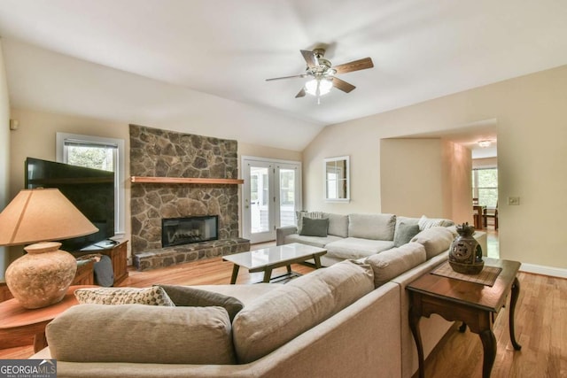 living room with wood finished floors, ceiling fan, lofted ceiling, and plenty of natural light