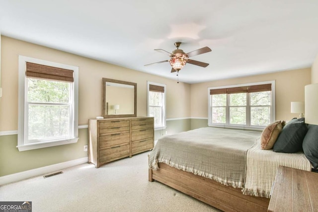 bedroom featuring carpet flooring, visible vents, baseboards, and a ceiling fan