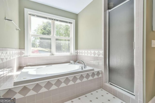 full bathroom featuring tile patterned floors, a stall shower, and a garden tub