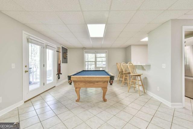 recreation room with light tile patterned floors, pool table, a drop ceiling, and baseboards