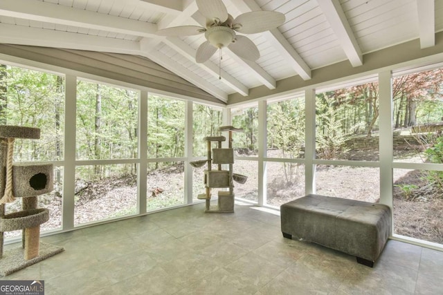 sunroom with plenty of natural light, a ceiling fan, and lofted ceiling with beams