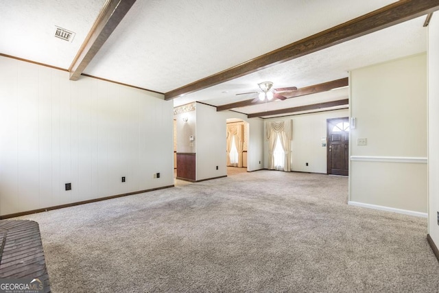 2237 W Elm St, Wrightsville, GA 31096 - unfurnished living room with beamed ceiling, carpet, visible vents, and ceiling fan