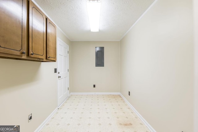 2237 W Elm St, Wrightsville, GA 31096 - laundry room featuring light floors, electric panel, baseboards, cabinet space, and a textured ceiling