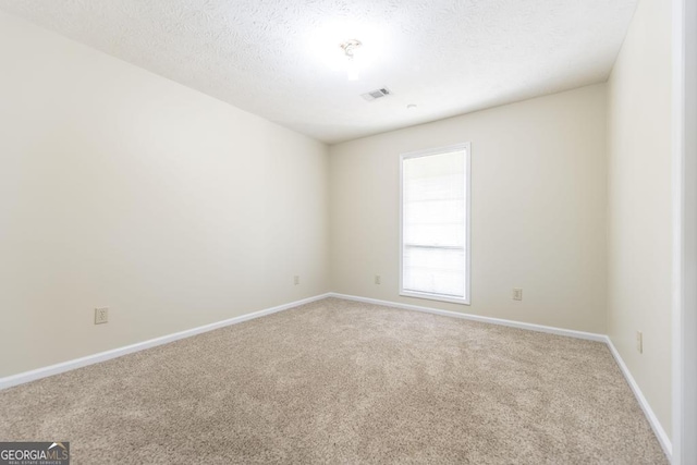 2237 W Elm St, Wrightsville, GA 31096 - spare room with baseboards, visible vents, and carpet floors