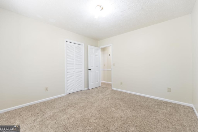 2237 W Elm St, Wrightsville, GA 31096 - empty room featuring baseboards and light colored carpet