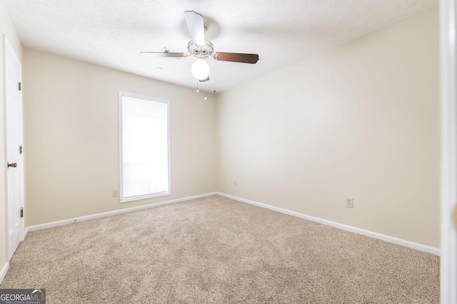 2237 W Elm St, Wrightsville, GA 31096 - spare room featuring ceiling fan, carpet floors, a textured ceiling, and baseboards
