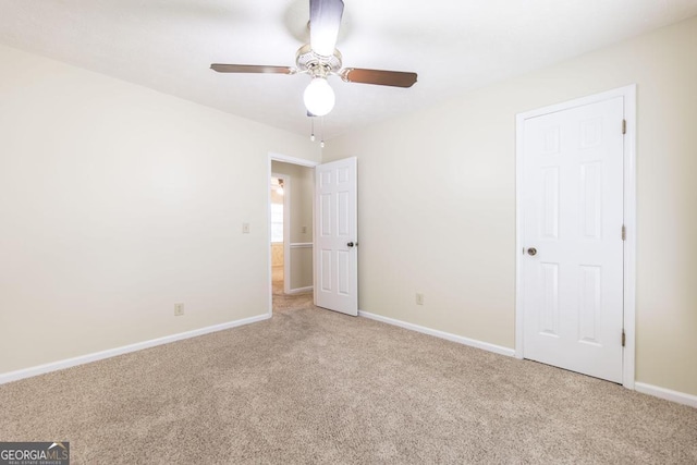 2237 W Elm St, Wrightsville, GA 31096 - unfurnished bedroom featuring a ceiling fan, baseboards, and light carpet