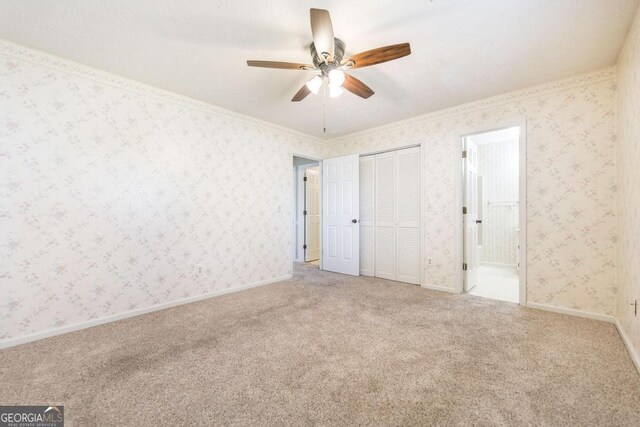 2237 W Elm St, Wrightsville, GA 31096 - unfurnished bedroom with ensuite bathroom, carpet floors, and a closet