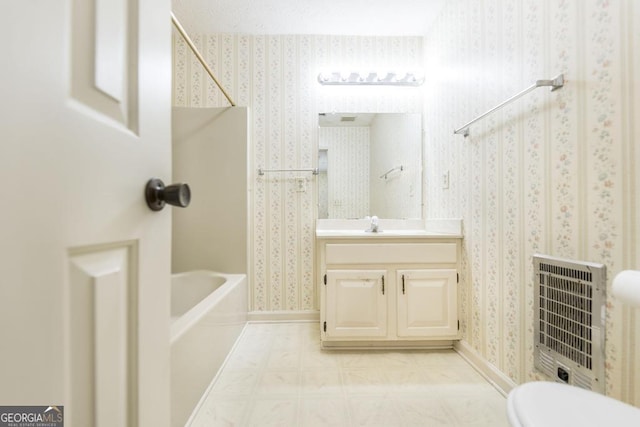 2237 W Elm St, Wrightsville, GA 31096 - full bathroom with wallpapered walls, tile patterned floors, heating unit, bathing tub / shower combination, and vanity