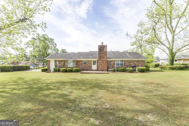 2237 W Elm St, Wrightsville, GA 31096 - rear view of property with brick siding, a lawn, and a chimney