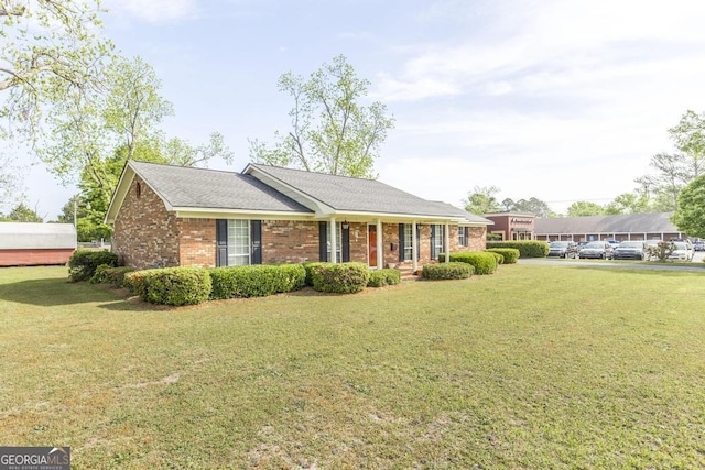2237 W Elm St, Wrightsville, GA 31096 - exterior space with a porch, brick siding, and a yard