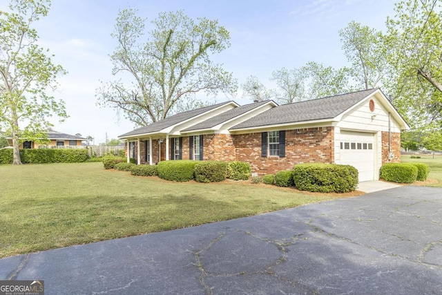 2237 W Elm St, Wrightsville, GA 31096 - ranch-style house featuring driveway, brick siding, an attached garage, a shingled roof, and a front yard