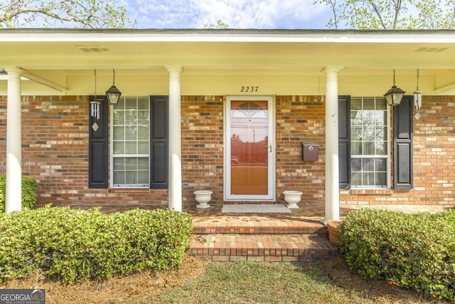 2237 W Elm St, Wrightsville, GA 31096 - doorway to property with brick siding and covered porch