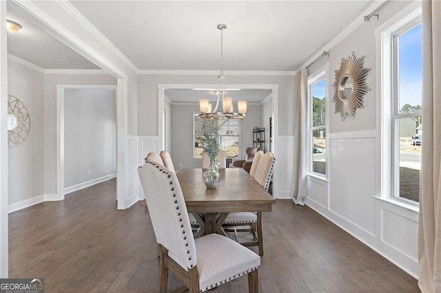 dining room with a decorative wall, an inviting chandelier, wainscoting, and dark wood finished floors
