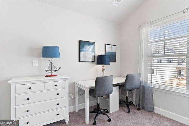office featuring visible vents, baseboards, carpet, and vaulted ceiling