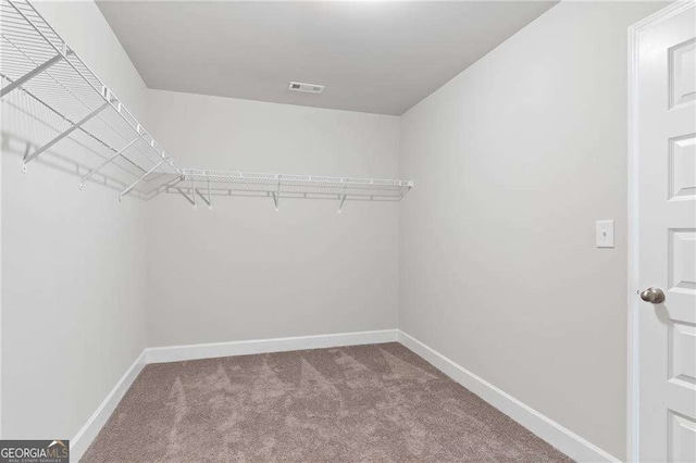 walk in closet with carpet floors and visible vents