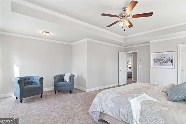 bedroom with crown molding, baseboards, a raised ceiling, and carpet
