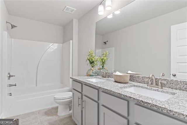 bathroom featuring a sink, toilet, double vanity, and shower / bath combination