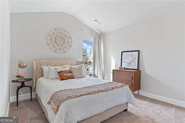 carpeted bedroom with visible vents, baseboards, and vaulted ceiling