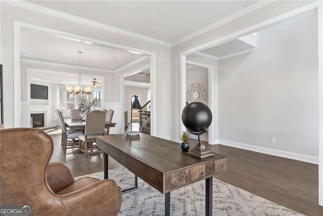 office with a chandelier, baseboards, crown molding, and wood finished floors