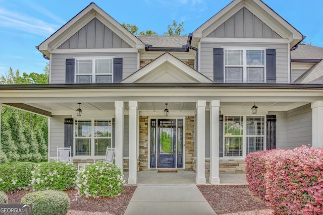 185 Discovery Lake Dr, Fayetteville, GA 30215 - doorway to property with a porch, board and batten siding, and stone siding