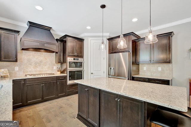 185 Discovery Lake Dr, Fayetteville, GA 30215 - kitchen with dark brown cabinetry, ornamental molding, premium range hood, backsplash, and stainless steel appliances