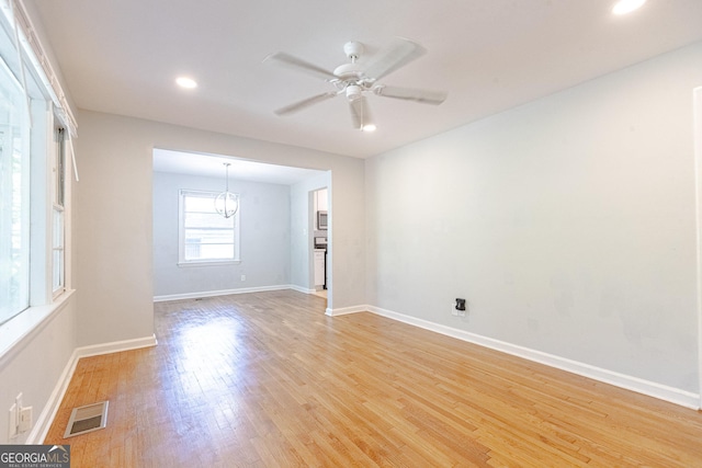 145 Holly Rd NW, Atlanta, GA 30314 - spare room featuring baseboards, light wood-style floors, visible vents, and ceiling fan with notable chandelier