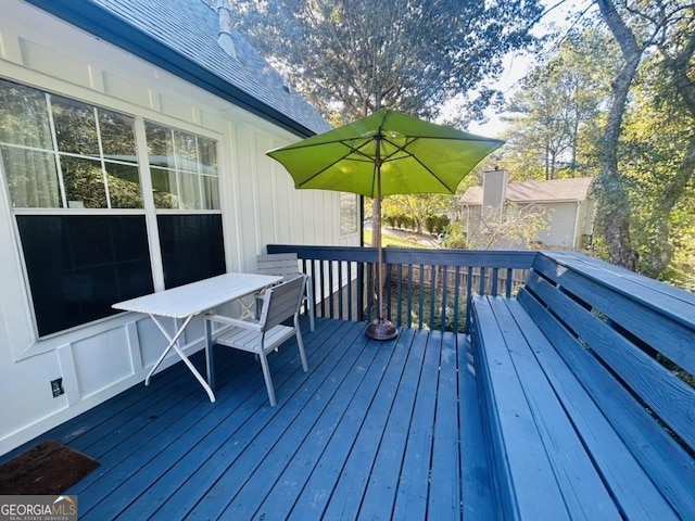 wooden deck featuring outdoor dining area