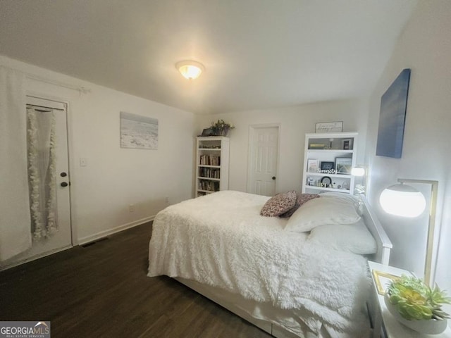bedroom with baseboards and dark wood-style floors