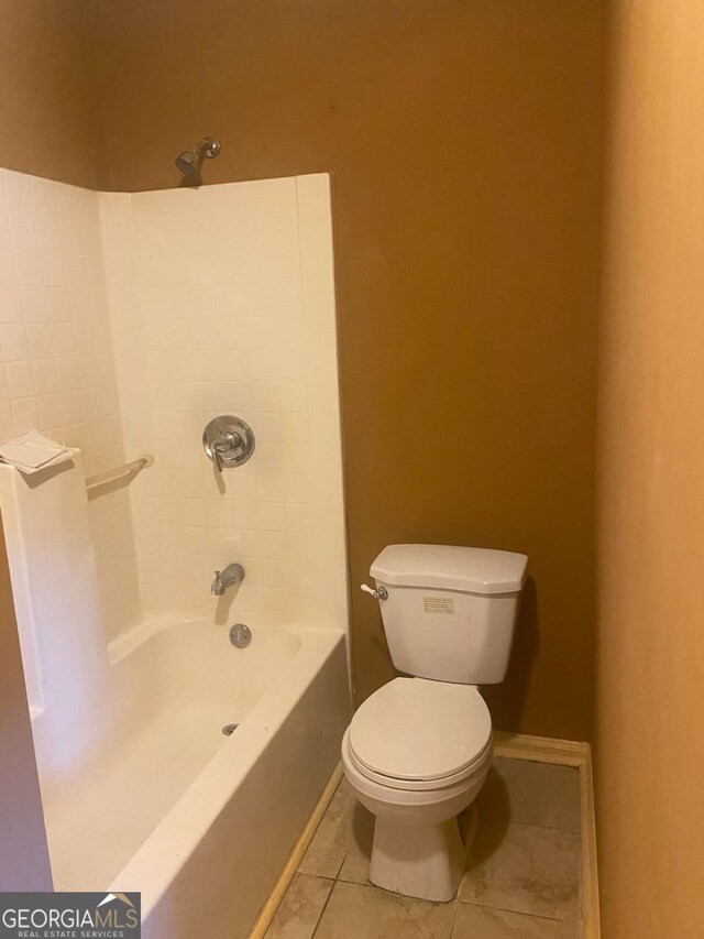 full bathroom featuring tile patterned flooring, shower / bathtub combination, baseboards, and toilet