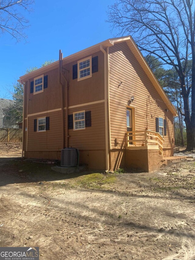back of property featuring cooling unit