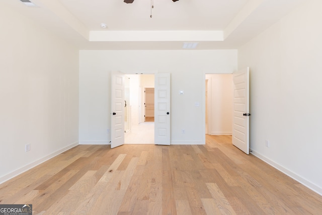 8415 Beryl Overlook, Gainesville, GA 30506 - unfurnished bedroom featuring a tray ceiling, light wood finished floors, baseboards, and ceiling fan
