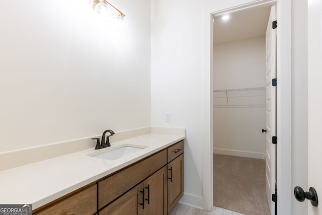 8415 Beryl Overlook, Gainesville, GA 30506 - bathroom with vanity, baseboards, and a spacious closet