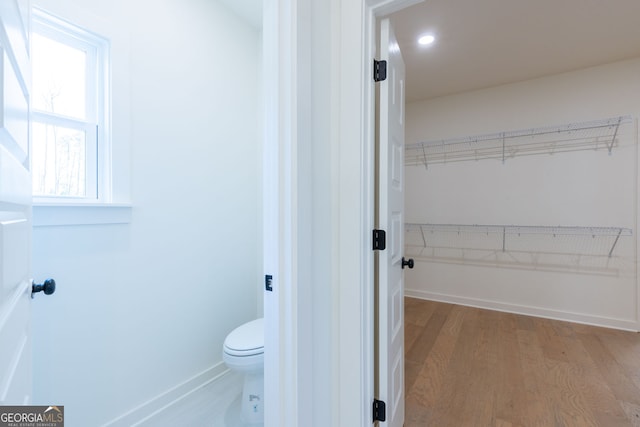 8415 Beryl Overlook, Gainesville, GA 30506 - bathroom with wood finished floors, a spacious closet, toilet, baseboards, and recessed lighting