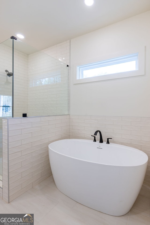 8415 Beryl Overlook, Gainesville, GA 30506 - bathroom with tile walls, a freestanding tub, a tile shower, tile patterned floors, and recessed lighting